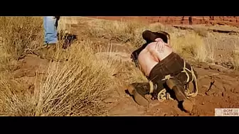 Large-rear-end blonde gets her butt-hole whipped, then gets rough anal sex in dirt and piss -- a real BDSM session outdoors in the Western USA with Rebel Rhyder